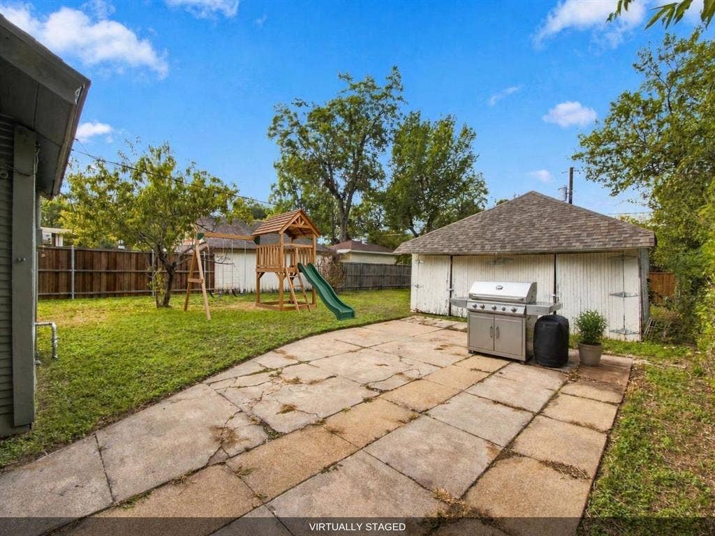 Backyard with virtually staged grill and playset