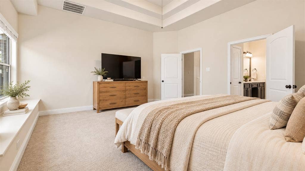 632 Grisham Drive, Fate, TX 75087 Bedroom featuring a tray ceiling, plush carpeting, built-in window seat, and dual-panel interior doors