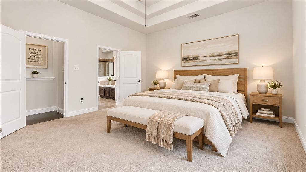 632 Grisham Drive, Fate, TX 75087 Spacious room featuring a tiered tray ceiling, neutral wall tones, plush wall-to-wall carpeting, and dual interior doors