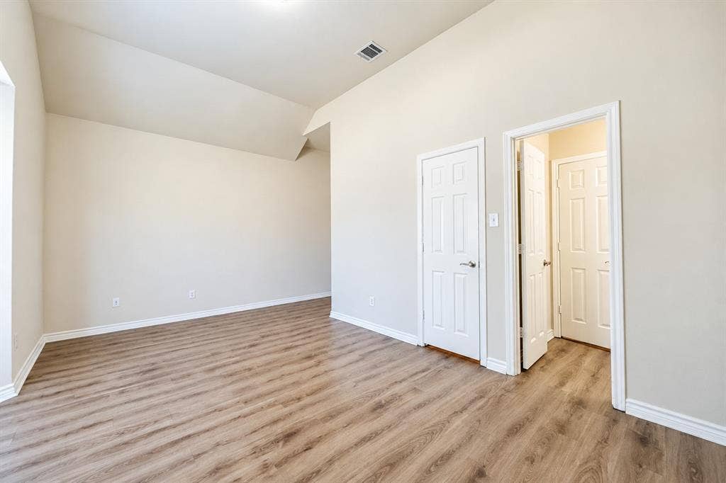 1736 Blue Stream Drive, DeSoto, TX 75115 Vaulted ceilings, wood-look LVP flooring, and neutral wall tones
