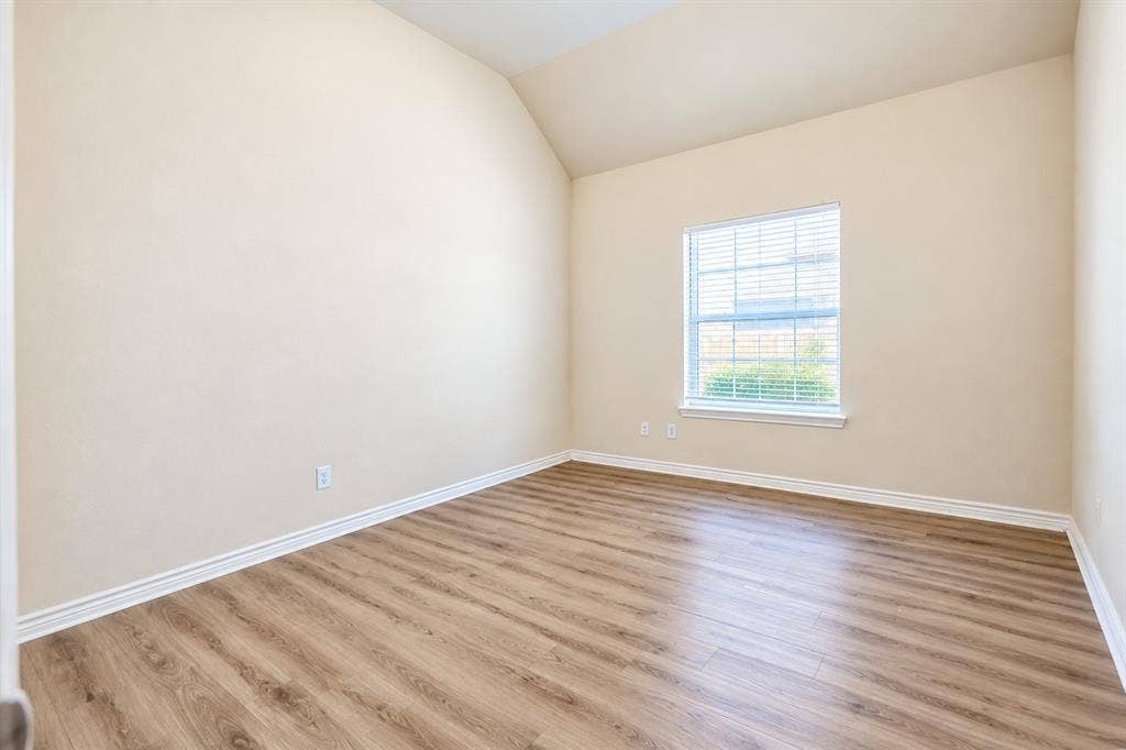 1736 Blue Stream Drive, DeSoto, TX 75115 Vaulted ceilings, wood-look LVP flooring, and a single-pane window with installed blinds