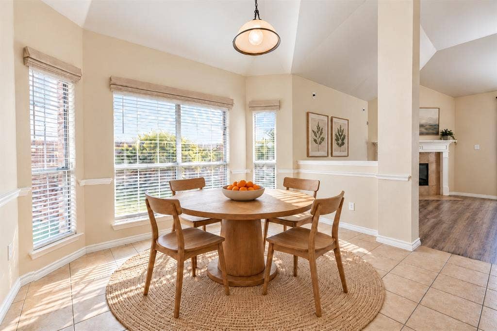 1736 Blue Stream Drive, DeSoto, TX 75115 Vaulted ceilings, expansive multi-pane windows, ceramic tile flooring, and a pendant light fixture. *Virtually staged to show potential*