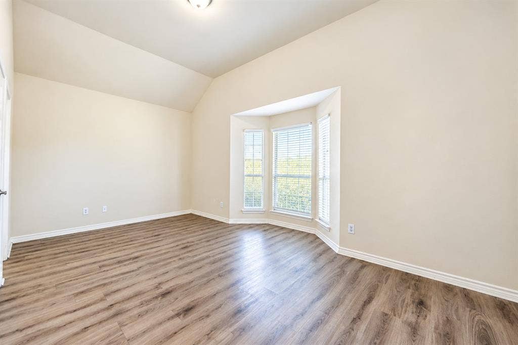 1736 Blue Stream Drive, DeSoto, TX 75115 Vaulted ceilings, wood-look LVP flooring, and a triple-pane bay window