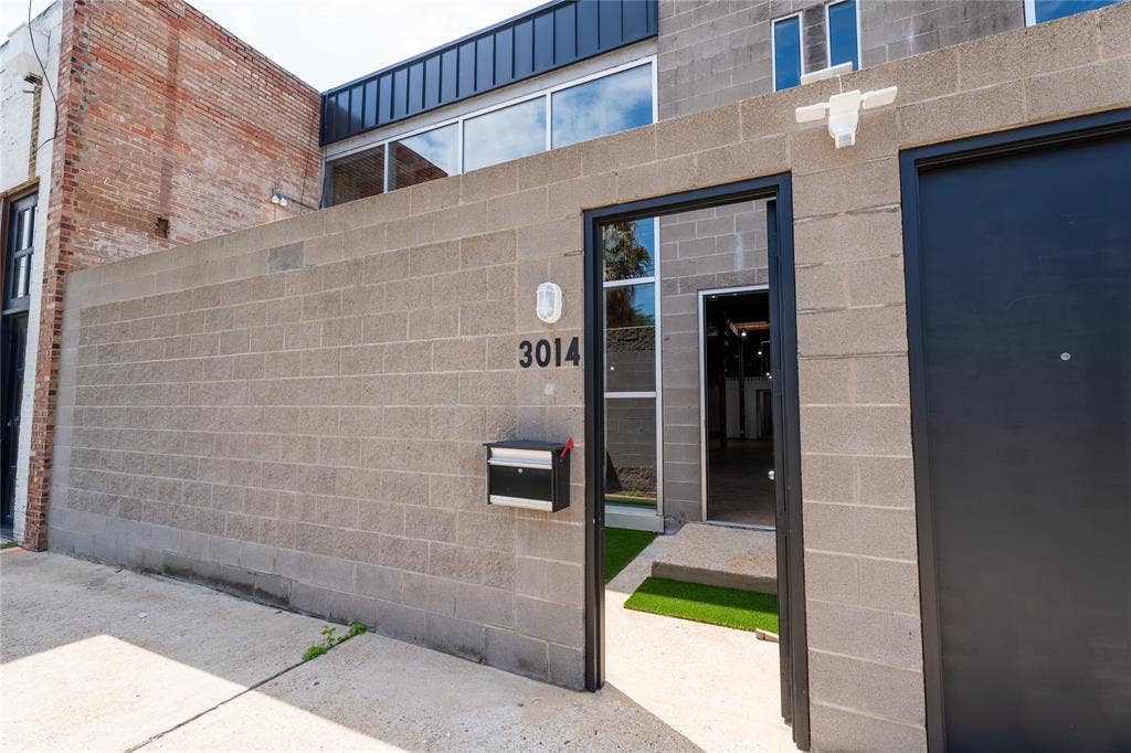 3014 Canton Street, Dallas, TX 75226 Industrial concrete masonry unit facade featuring a metal roofline, expansive glass windows, and a private entryway