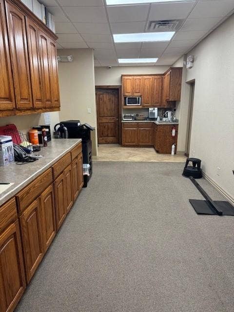 1831 W Louisiana Street, McKinney, TX 75069 Custom wood cabinetry, stone-composite countertops, built-in microwave, tile flooring, and solid wood interior doors