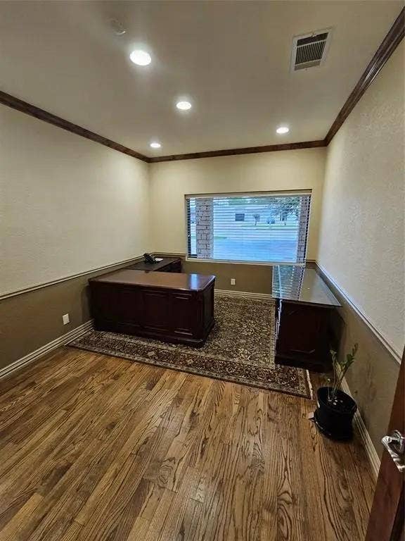 1831 W Louisiana Street, McKinney, TX 75069 Room featuring wood-finish flooring, two-tone paint with chair rail molding, crown molding, and recessed lighting