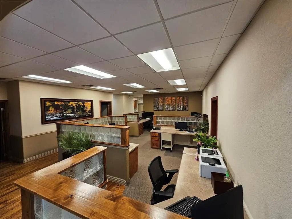1831 W Louisiana Street, McKinney, TX 75069 Drop ceiling with recessed fluorescent lighting, custom wood-capped glass partition walls, and textured wall surfaces