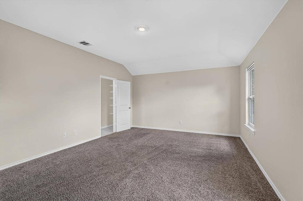 114 Real Quiet Lane, Caddo Mills, TX 75135 Neutral wall finishes, vaulted ceiling, carpeting, and a built-in closet with shelving