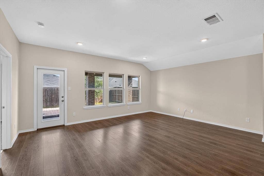 114 Real Quiet Lane, Caddo Mills, TX 75135 Vaulted ceilings, wood-finish flooring, recessed lighting, and triple windows with a full-glass exterior door