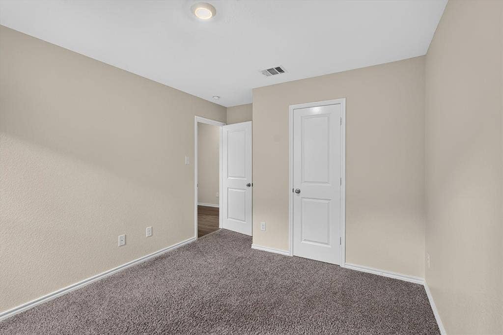 114 Real Quiet Lane, Caddo Mills, TX 75135 Neutral-toned interior space featuring wall-to-wall carpeting, two-panel interior doors, and recessed lighting