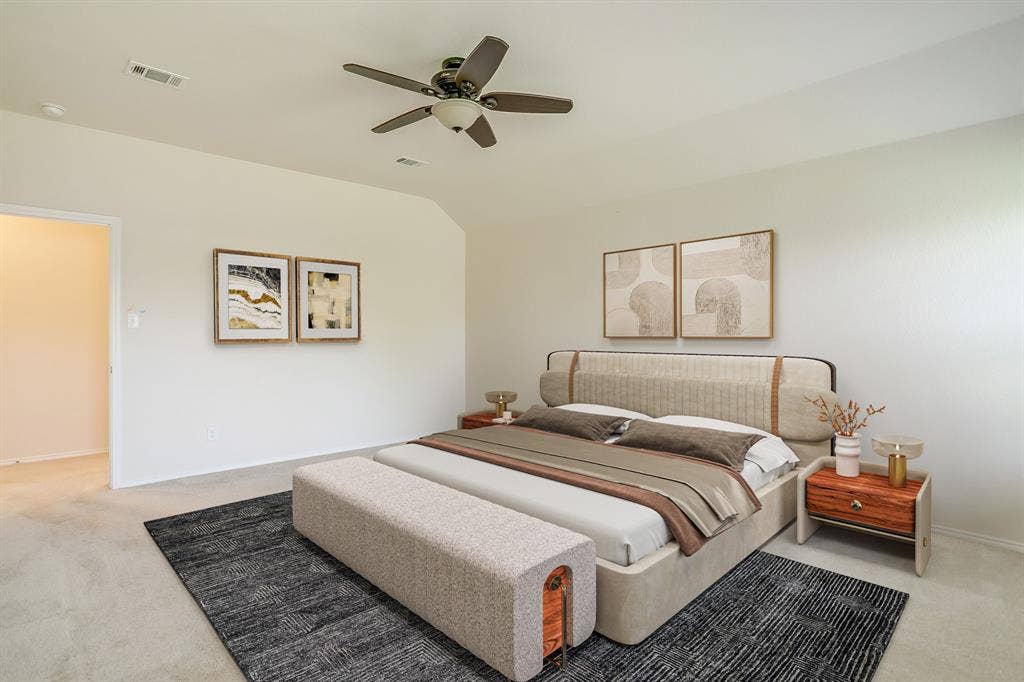 Neutral-toned room featuring a vaulted ceiling and a ceiling fan with integrated lighting