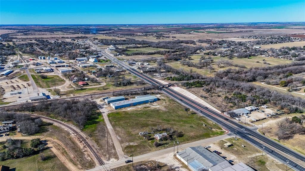 110 1st Street, McGregor, TX 76657 Expansive acreage featuring primary road frontage, proximity to rail lines, open topographical terrain, and industrial-zoned commercial structures