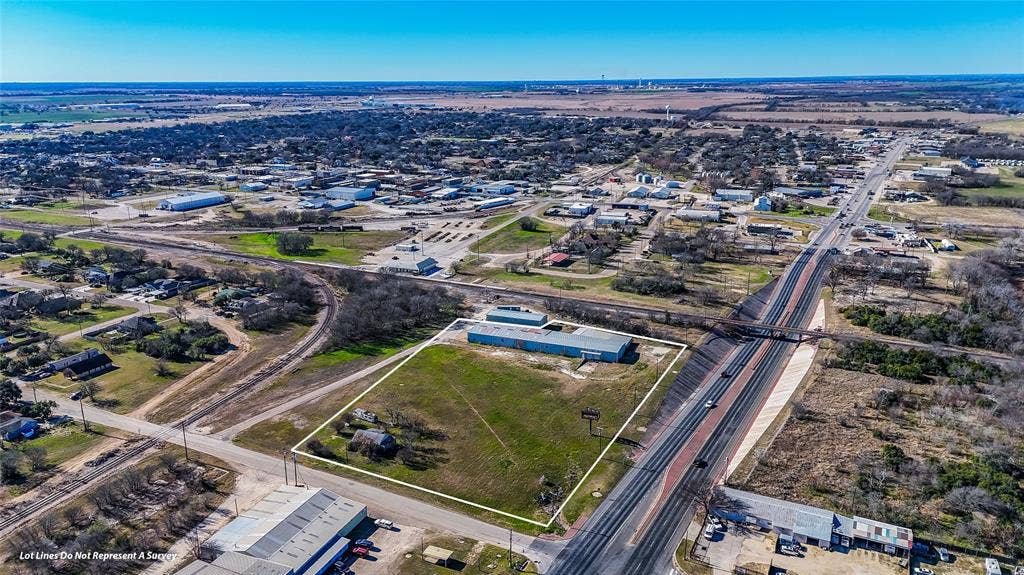 110 1st Street, McGregor, TX 76657 Expansive acreage featuring prominent highway frontage and existing metal structures