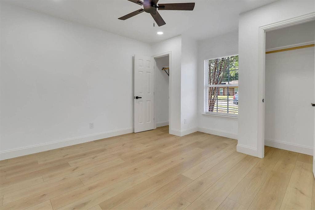 1913 Sandra Kay Lane, Arlington, TX 76015 Room featuring wood-finish flooring, recessed lighting, a ceiling fan, a single-pane window, and two separate reach-in closets