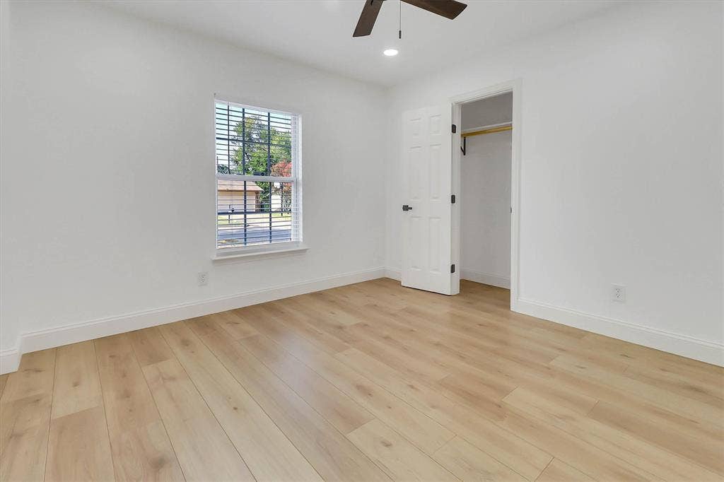 1913 Sandra Kay Lane, Arlington, TX 76015 Neutral-toned wood-finish flooring, recessed lighting, ceiling fan, single-hung window, and a reach-in closet with built-in rod