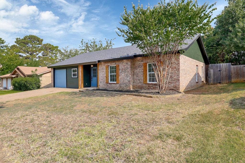 1913 Sandra Kay Lane, Arlington, TX 76015 Single-story brick exterior featuring wooden shutter accents, an attached garage, and a timber privacy fence
