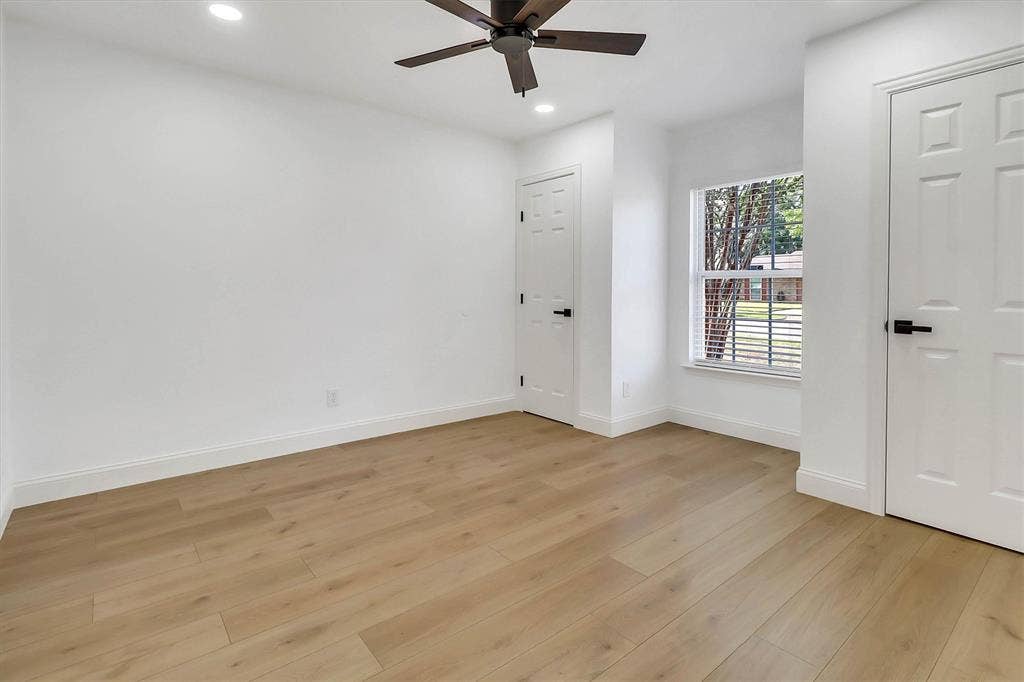1913 Sandra Kay Lane, Arlington, TX 76015 Wood-finish flooring, recessed lighting, matte black hardware, single-pane window, and a ceiling fan