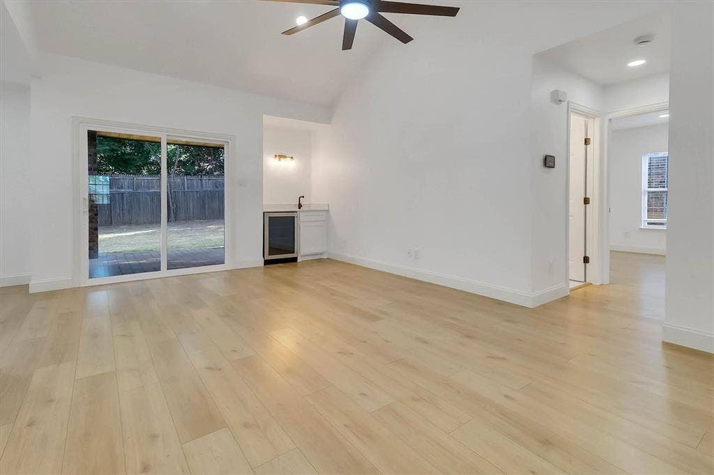 1913 Sandra Kay Lane, Arlington, TX 76015 Vaulted ceilings, wood-finish flooring, built-in wet bar with under-counter beverage refrigerator, and sliding glass doors