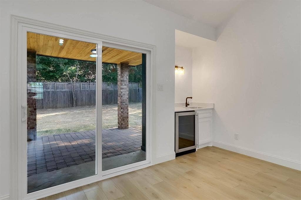 1913 Sandra Kay Lane, Arlington, TX 76015 Sliding glass door leading to a covered brick patio with a wood-plank ceiling