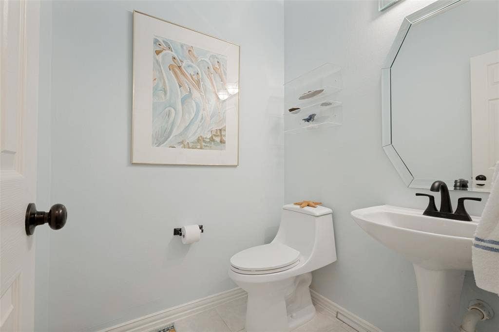 Downstairs half bathroom is located across from the 2nd bedroom.