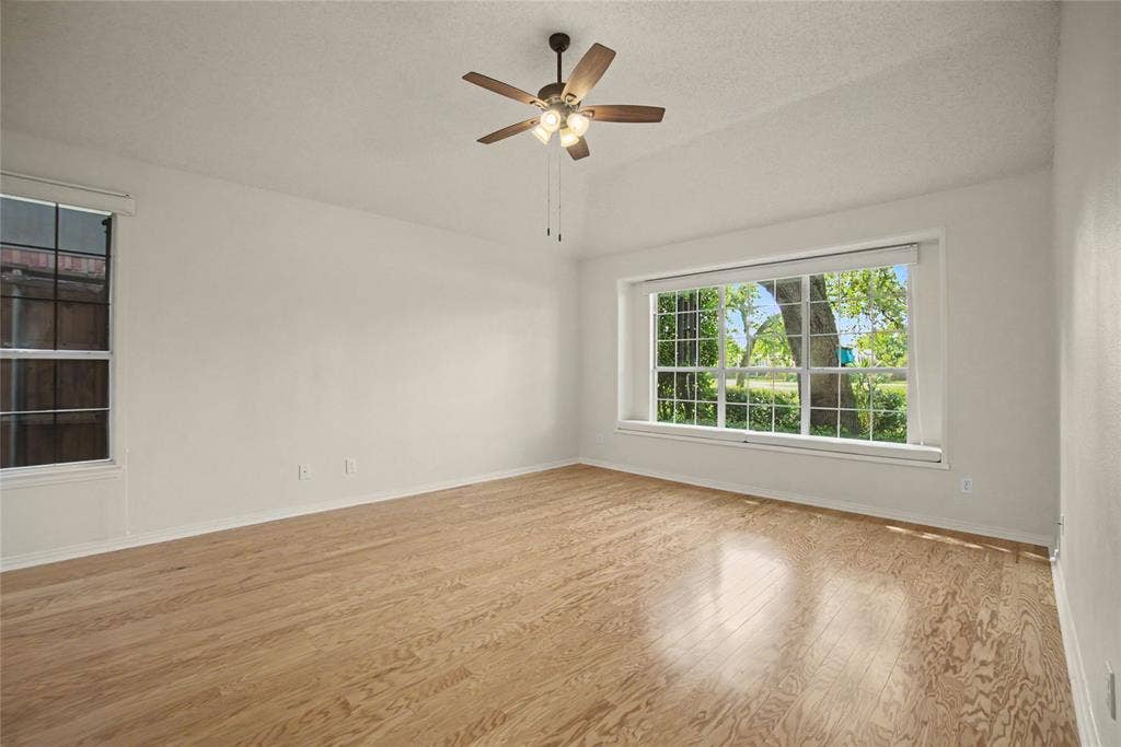 A spacious retreat located in the back with lush landscape and golf views. Finished with hardwoods, a cushioned window seat and sitting area.