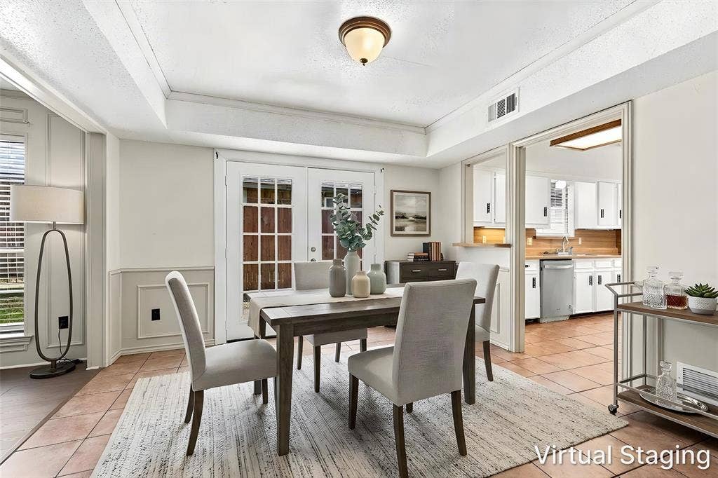2145 Willow Place, #A, Carrollton, TX 75006 Dining area featuring dual-pane French doors with muntins, tiled flooring, crown molding, and wainscoting