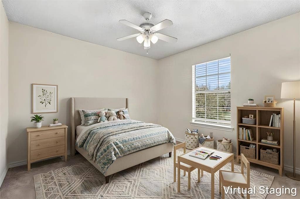 2145 Willow Place, #A, Carrollton, TX 75006 Neutral-toned interior space featuring wall-to-wall carpeting, a multi-pane window, and a central ceiling fan with integrated lighting