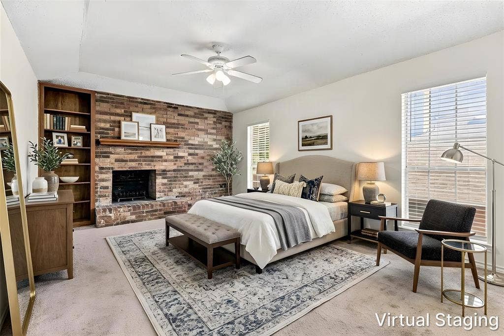 2145 Willow Place, #A, Carrollton, TX 75006 Exposed brick fireplace with a wood mantel, built-in floor-to-ceiling shelving, tray ceiling, and a ceiling fan with integrated lighting
