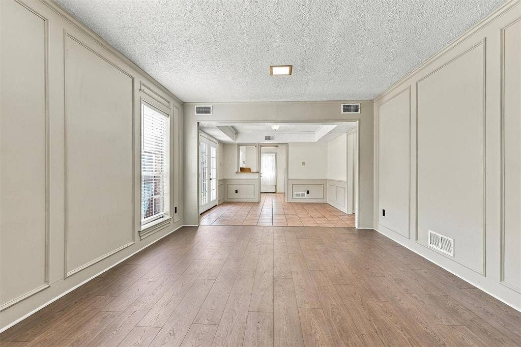 2145 Willow Place, #A, Carrollton, TX 75006 Room featuring wood-finish flooring, decorative wall molding, and tiled surfaces with French doors