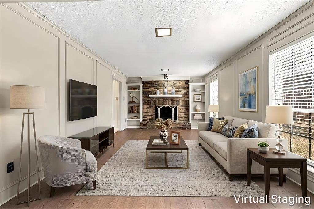 2145 Willow Place, #A, Carrollton, TX 75006 Living room featuring paneled walls, wood-finish flooring, a brick fireplace with a mantel, and built-in shelving