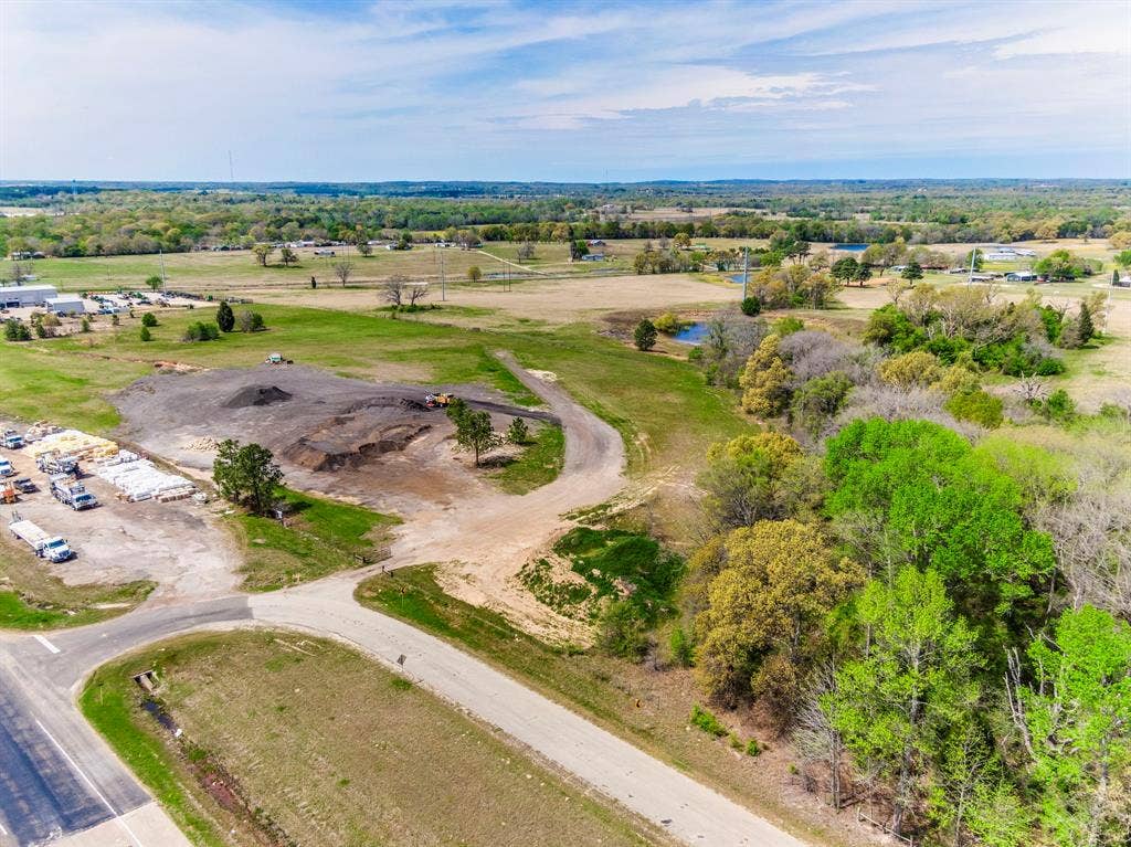 317 Fm 1616, Athens, TX 75752 Expansive acreage featuring cleared topography, natural clusters of mature trees, an on-site pond, and gravel road access