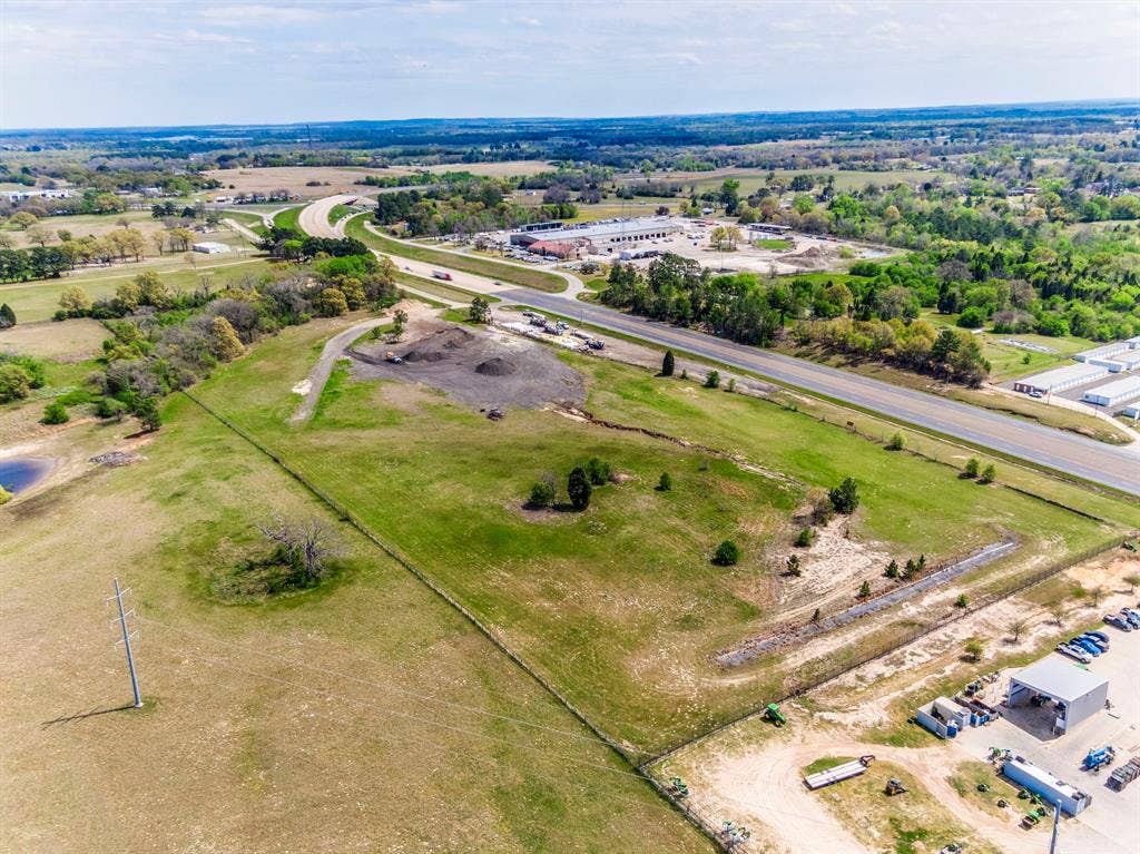 317 Fm 1616, Athens, TX 75752 Expansive parcel of land featuring open acreage, mature trees, and direct frontage to a paved highway