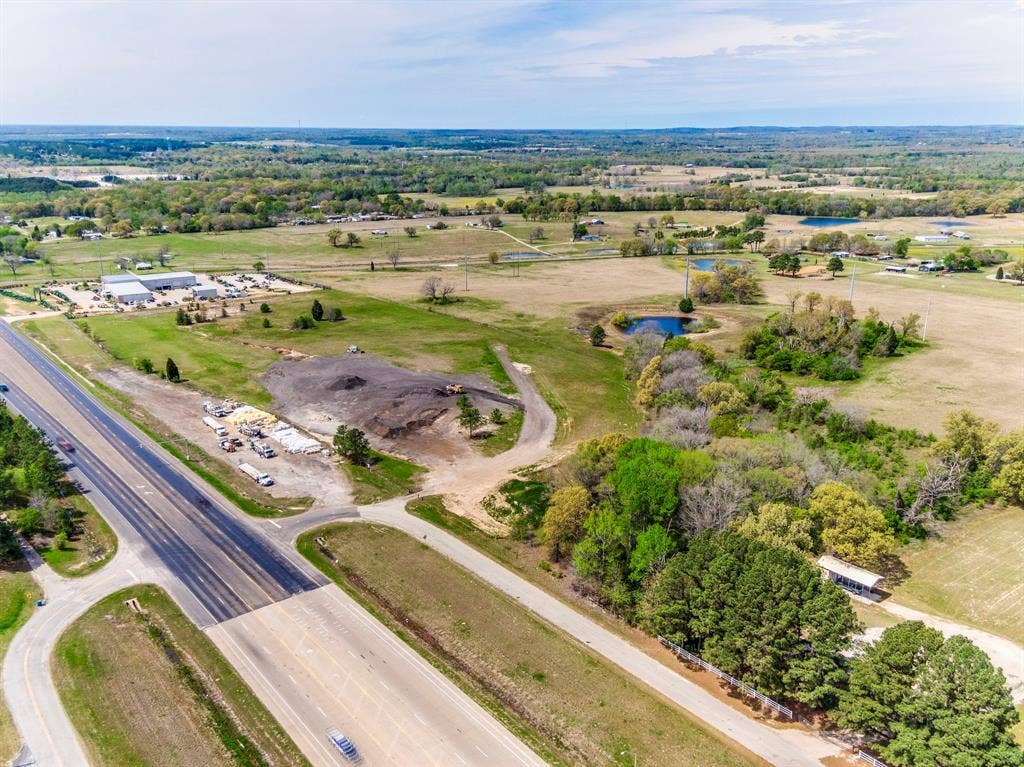 317 Fm 1616, Athens, TX 75752 Expansive acreage featuring cleared land, mature tree clusters, a natural pond, and direct access to a major thoroughfare