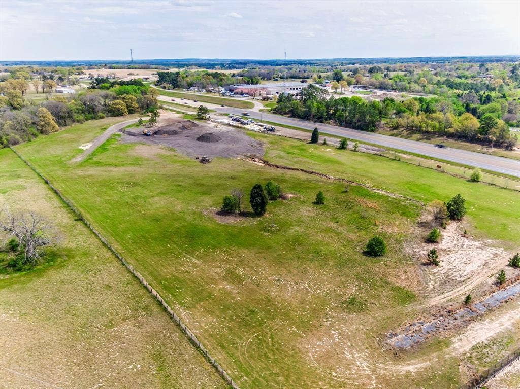 317 Fm 1616, Athens, TX 75752 Expansive acreage featuring cleared level terrain, established perimeter fencing, mature trees, and direct frontage to a paved thoroughfare