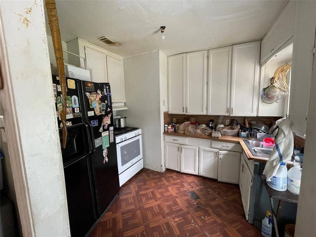 1115 Pine Street, Grand Prairie, TX 75050 Kitchen featuring white cabinetry, wooden countertops, tile flooring, and an integrated stove