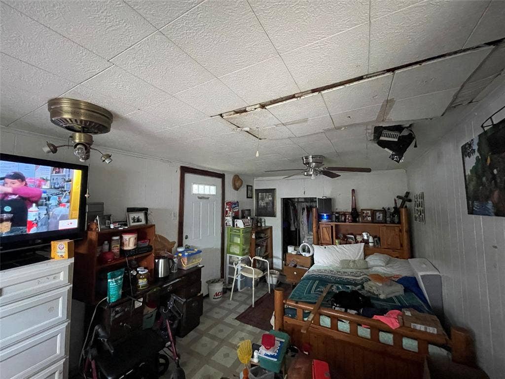 1115 Pine Street, Grand Prairie, TX 75050 Room featuring a six-panel exterior entry door and two ceiling-mounted fans