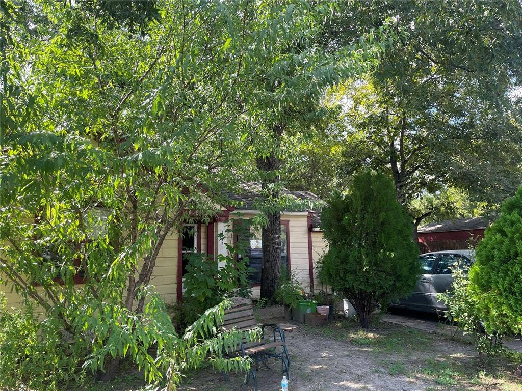 1115 Pine Street, Grand Prairie, TX 75050 Exterior featuring light-toned horizontal siding, dark-toned trim, and mature landscaping