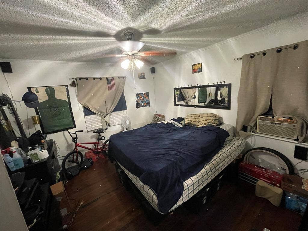 1115 Pine Street, Grand Prairie, TX 75050 Hardwood flooring, ceiling fan with integrated light fixture, and wall-mounted mirror