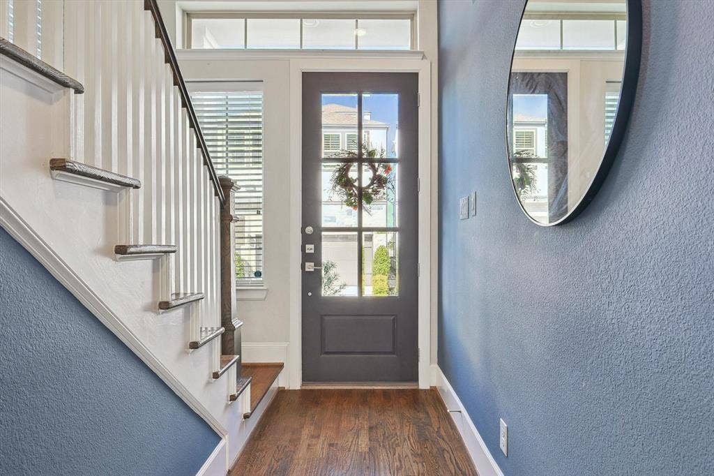 Foyer entrance with dark wood-type flooring