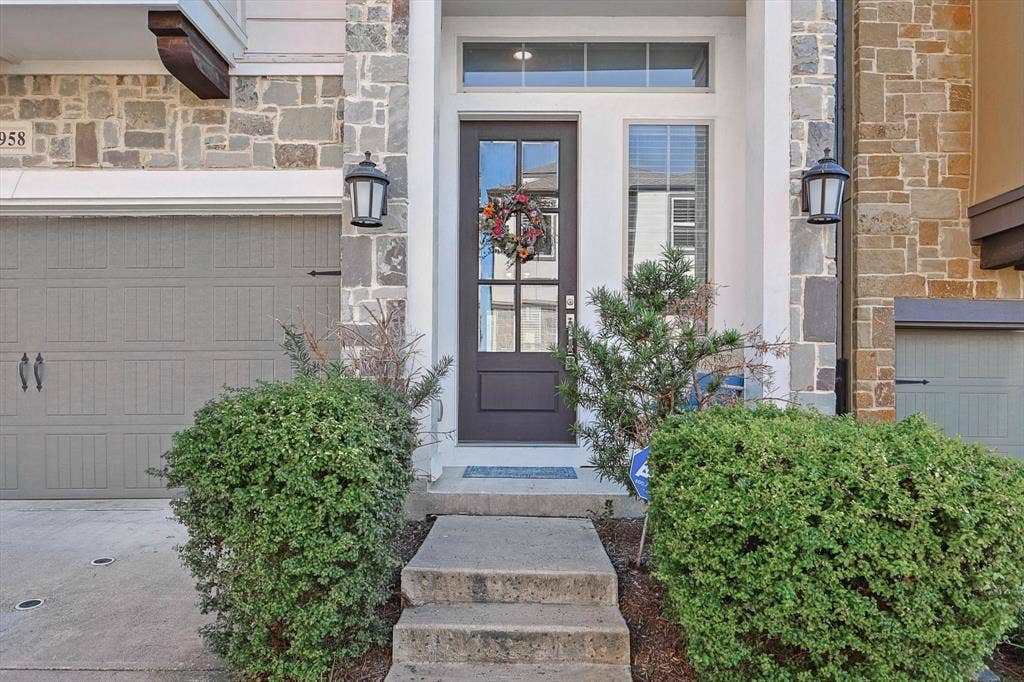Doorway to property featuring a garage