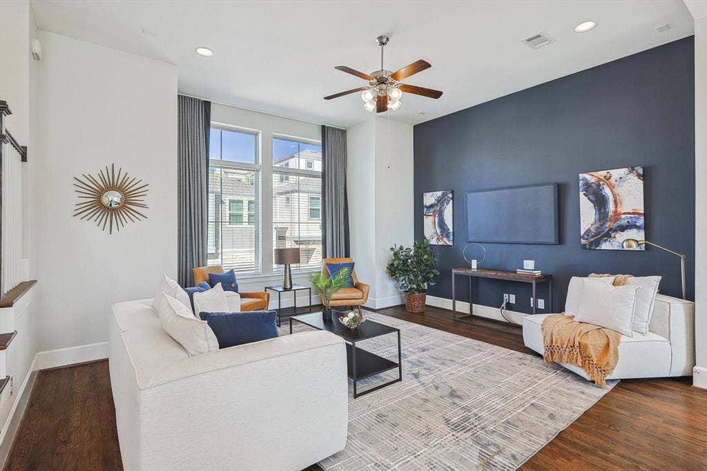 Living room with hardwood / wood-style floors and ceiling fan