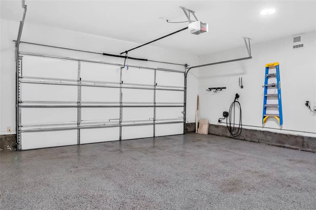 Sloped ceiling featuring two skylights, wood-finish flooring, and recessed ceiling lighting