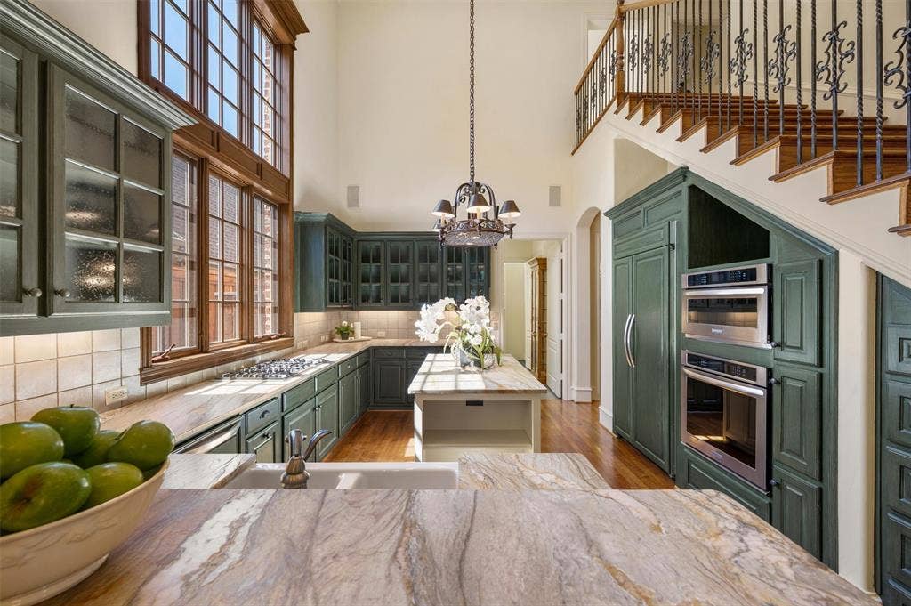 Two story windows offer a bright and cheery kitchen.