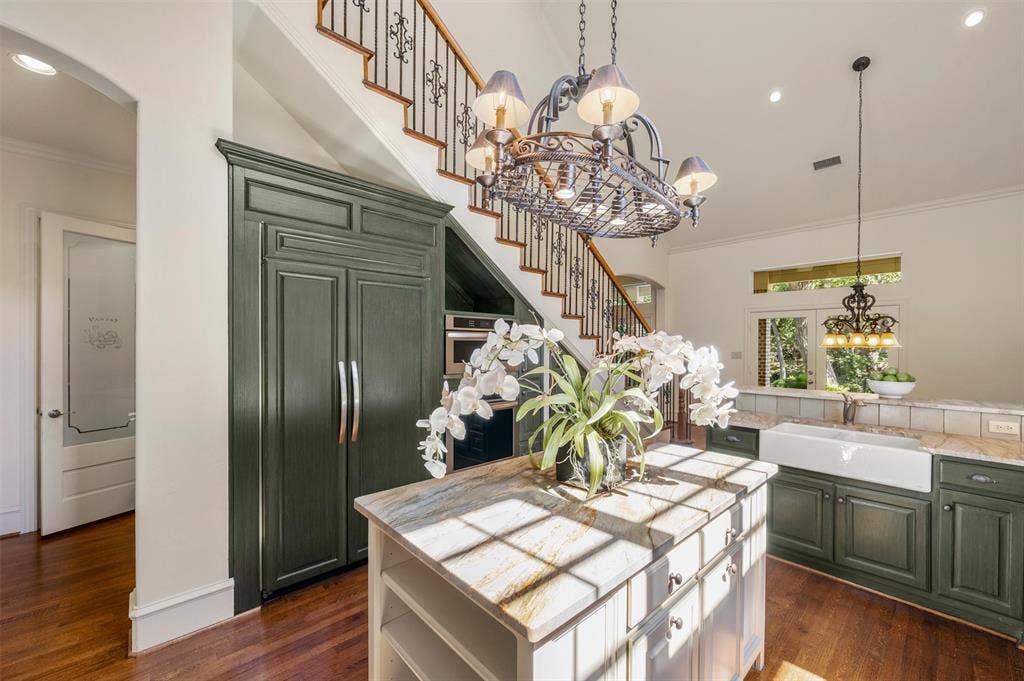 Built-in refrigerator and rare leathered granite countertop that is such a serene natural color. Must see!