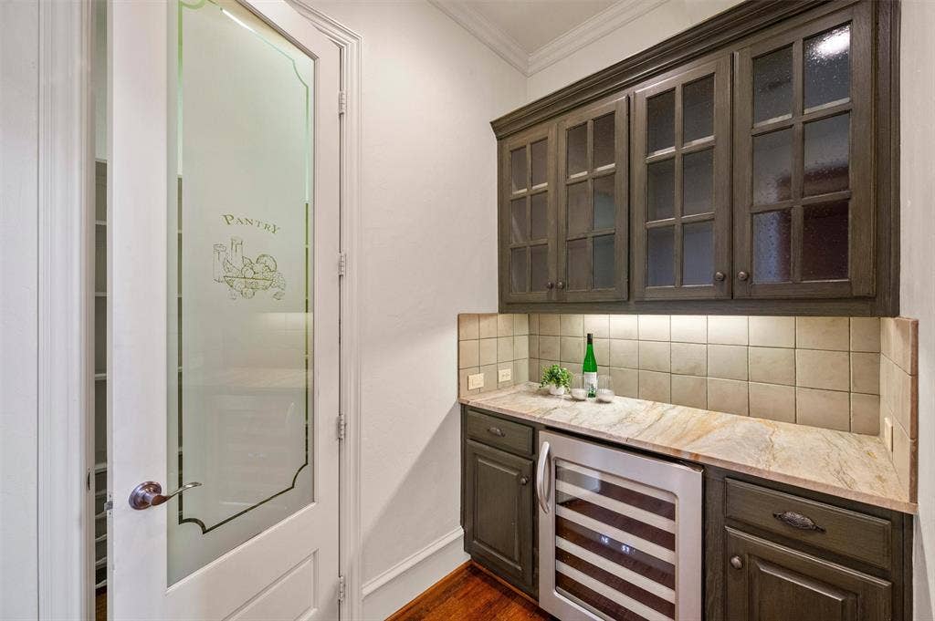 Butlers pantry with beverage refrigerator and walk in panty. Leads to formal dining room OR kitchen.
