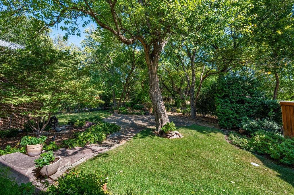 This property backs to an acre property set far back and this provides an expansive park view with the neighboring house in the distance.  LUSH!