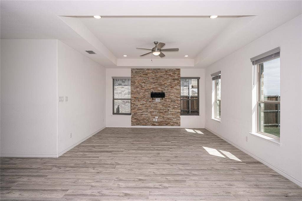 3508 Highland Bayou Drive, Prosper, TX 75078 Living room with light hardwood / wood-style flooring, ceiling fan, and tray ceiling