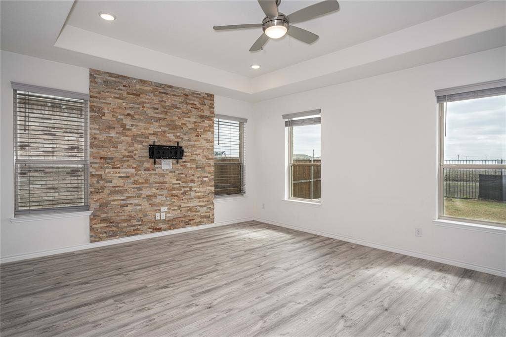 3508 Highland Bayou Drive, Prosper, TX 75078 Living room with ceiling fan, a tray ceiling, and light hardwood / wood-style floors