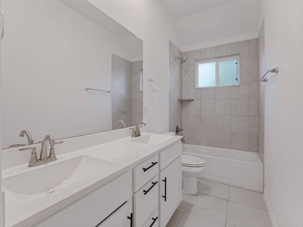 336 Clark Street, Irving, TX 75060 Additional bathroom featuring dual sinks and a tub and shower combination