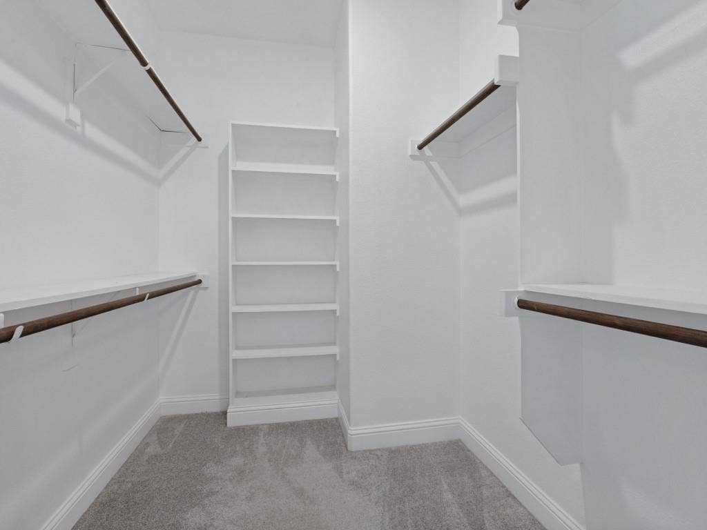 336 Clark Street, Irving, TX 75060 Generous walk-in closet with built-in shelving and multiple hanging areas
